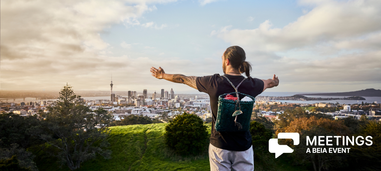 Man stretching his arms overlooking Auckland city