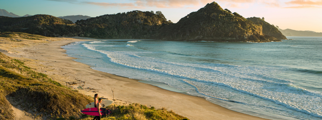 Surfers at Medlands Beach, Great Barrier Island