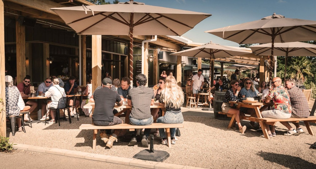 People dining outdoors at The Heke Kitchen