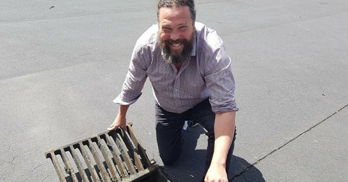 Photo of Mike Hannah from Stormwater 360  looking at the camera with his litter trap 