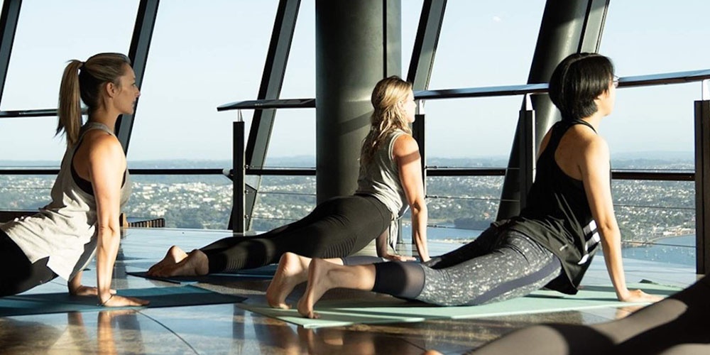 Three woman doing yoga at The Sky Tower