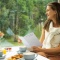 Photo of lady on a train with breakfast