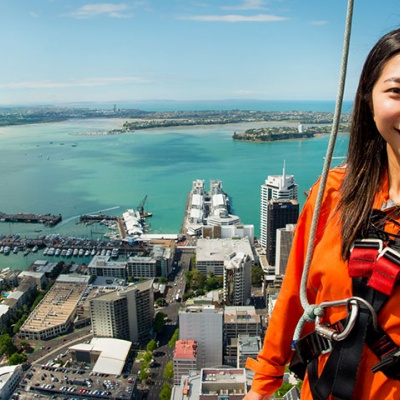 A lady and her friends enjoying an amazing view of Auckland from the SkyWalk